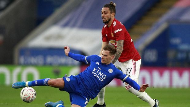 Leicester's Marc Albrighton, front, duels for the ball with Manchester United's Alex Telles during the English FA Cup quarter final soccer match between Leicester City and Manchester United at the King Power Stadium in Leicester, England, Sunday, March 21, 2021. (AP Photo/Ian Walton, Pool)