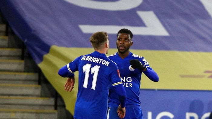 Leicesters Kelechi Iheanacho, right, celebrates with Leicesters Marc Albrighton after scoring his sides third goal during the English FA Cup quarter final soccer match between Leicester City and Manchester United at the King Power Stadium in Leicester, England, Sunday, March 21, 2021. (AP Photo/Ian Walton, Pool)