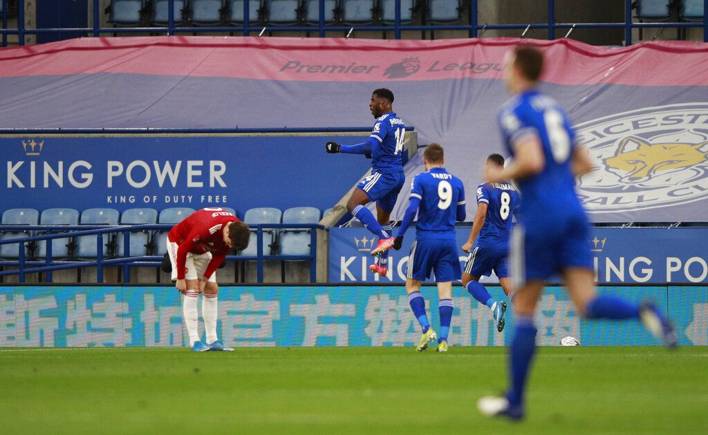 Manchester United's Paul Pogba, left, duels for the ball with Leicester's Kelechi Iheanacho during the English FA Cup quarter final soccer match between Leicester City and Manchester United at the King Power Stadium in Leicester, England, Sunday, March 21, 2021. (AP Photo/Ian Walton, Pool)