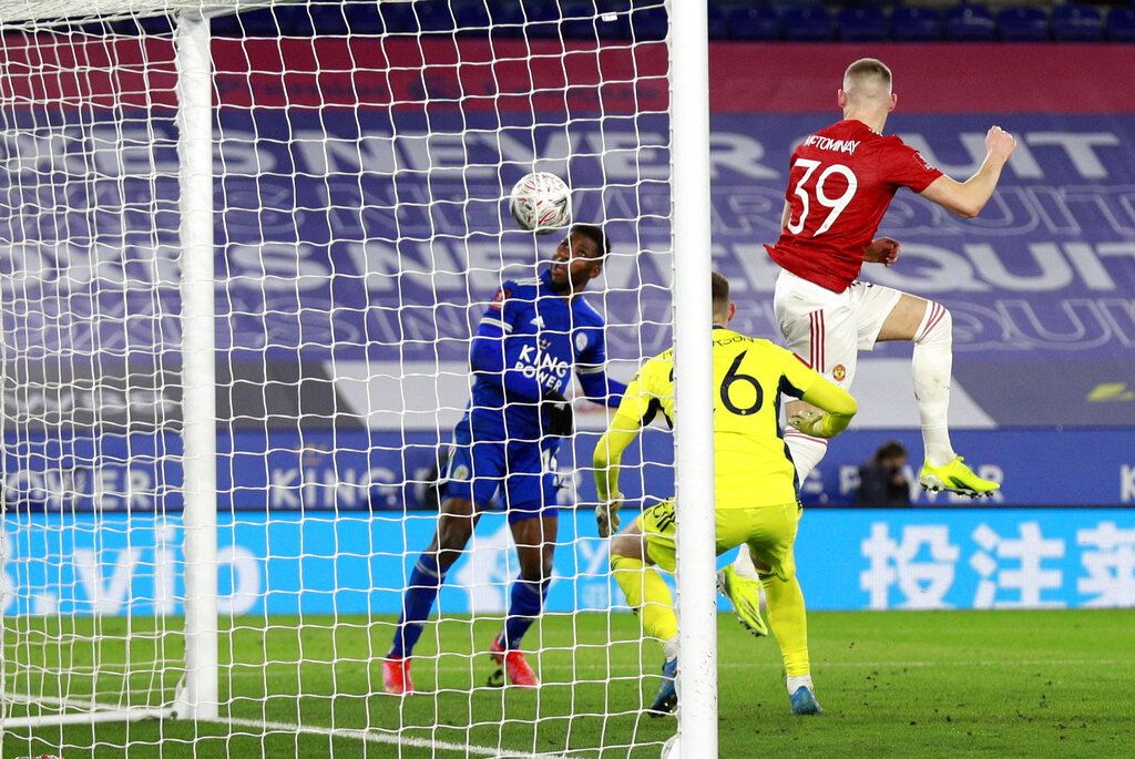 Leicester's Kelechi Iheanacho, left, scores his side's third goal during the English FA Cup quarter final soccer match between Leicester City and Manchester United at the King Power Stadium in Leicester, England, Sunday, March 21, 2021. (AP Photo/Ian Walton, Pool)