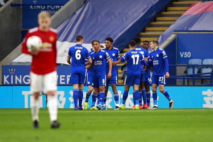 Leicesters Kelechi Iheanacho celebrates with teammates after scoring his sides opening goal during the English FA Cup quarter final soccer match between Leicester City and Manchester United at the King Power Stadium in Leicester, England, Sunday, March 21, 2021. (AP Photo/Ian Walton, Pool)