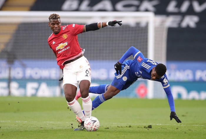 LEICESTER, ENGLAND - MARCH 21: Kelechi Iheanacho of Leicester City is challenged by Paul Pogba of Manchester United during the Emirates FA Cup Quarter Final  match between Leicester City and Manchester United at The King Power Stadium on March 21, 2021 in Leicester, England. Sporting stadiums around the UK remain under strict restrictions due to the Coronavirus Pandemic as Government social distancing laws prohibit fans inside venues resulting in games being played behind closed doors.  (Photo by Alex Pantling/Getty Images)