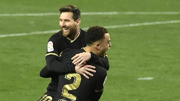 Barcelonas Sergino Dest celebrates with Barcelonas Lionel Messi scoring his sides 3rd goal during the Spanish La Liga soccer match between Real Sociedad and FC Barcelona at Reale Arena stadium in San Sebastian, Spain, Sunday, March. 21, 2021. (AP Photo/Alvaro Barrientos)