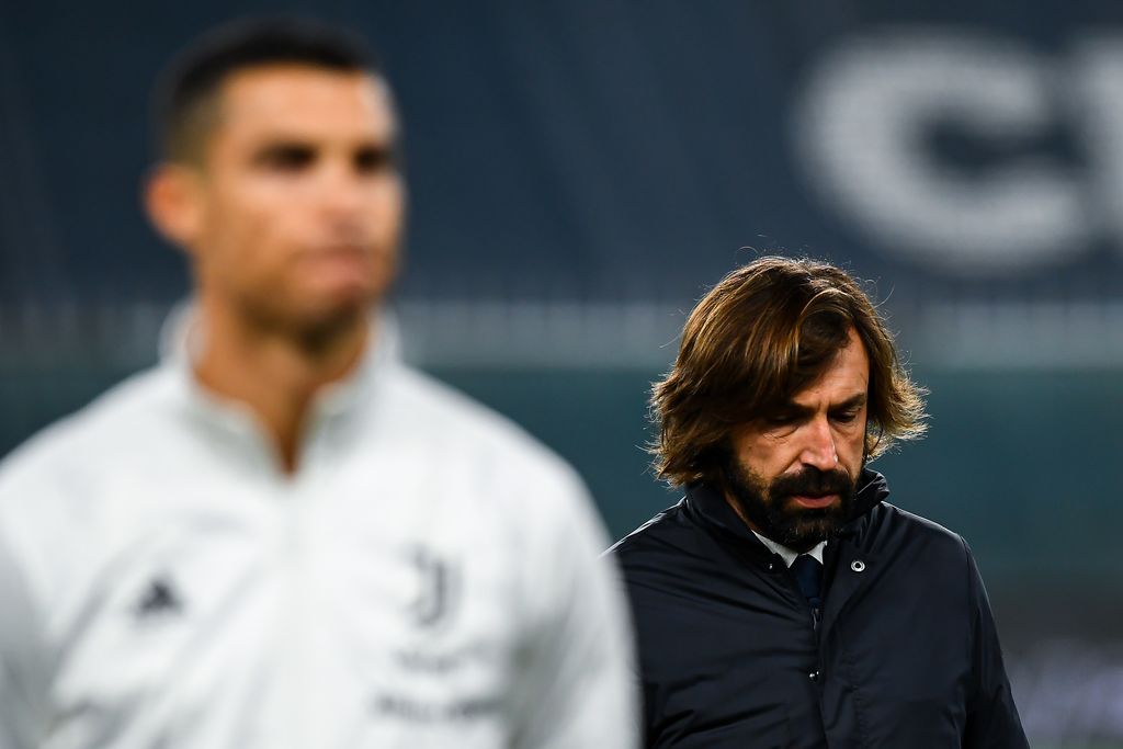 GENOA, ITALY - DECEMBER 13: Andrea Pirlo coach of Juventus (R) walks past Cristiano Ronaldo of Juventus before the Serie A match between Genoa CFC and Juventus Fc at Stadio Luigi Ferraris on December 13, 2020 in Genoa, Italy. (Photo by Paolo Rattini/Getty Images)