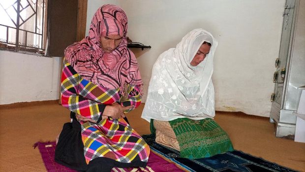 Rani Khan, a transgender woman who teaches the Koran at Pakistan's first transgender only madrasa or a religious school, prays with one of her students in Islamabad, Pakistan March 10, 2021. Picture taken March 10, 2021. REUTERS/Salahuddin NO RESALES. NO ARCHIVES