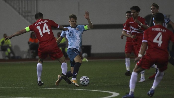 Norways Martin Ødegaard fights for the ball Gibraltars Chipolina during the World Cup 2022 group G qualifying soccer match between Gibraltar and Norway in Gibraltar, Wednesday March 24, 2021. (AP Photo/Javier Fergo)