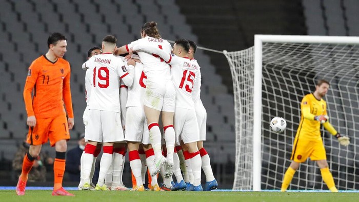 Turkeys Hakan Calhanoglu celebrates with his teammates after scoring his sides third goal during the World Cup 2022 group G qualifying soccer match between Turkey and Netherlands at the Ataturk Olimpiyat Stadium in Istanbul, Turkey, Wednesday, March 24, 2021. (Murad Sezer/Pool Photo via AP)