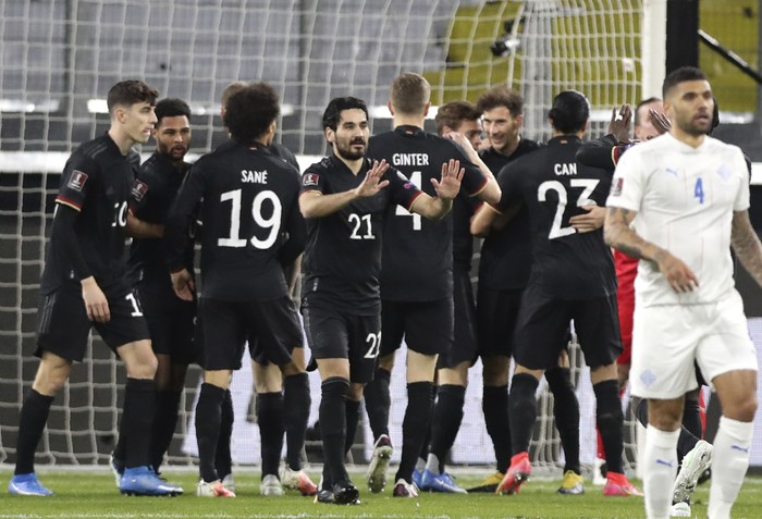 Germanys players celebrate after Germanys Leon Goretzka scored his sides opening goal during the World Cup 2022 group J qualifying soccer match between Germany and Iceland in Duisburg, Germany, Thursday, March 25, 2021. (AP Photo/Michael Sohn)