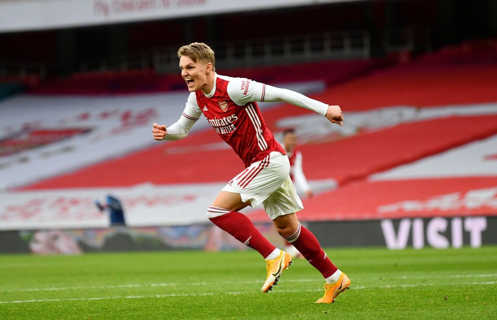 LONDON, ENGLAND - MARCH 14: Martin Odegaard of Arsenal celebrates after scoring their side's first goal during the Premier League match between Arsenal and Tottenham Hotspur at Emirates Stadium on March 14, 2021 in London, England. Sporting stadiums around the UK remain under strict restrictions due to the Coronavirus Pandemic as Government social distancing laws prohibit fans inside venues resulting in games being played behind closed doors. (Photo by Dan Mullan/Getty Images)