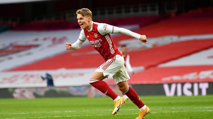 LONDON, ENGLAND - MARCH 14: Martin Odegaard of Arsenal celebrates after scoring their sides first goal during the Premier League match between Arsenal and Tottenham Hotspur at Emirates Stadium on March 14, 2021 in London, England. Sporting stadiums around the UK remain under strict restrictions due to the Coronavirus Pandemic as Government social distancing laws prohibit fans inside venues resulting in games being played behind closed doors. (Photo by Dan Mullan/Getty Images)