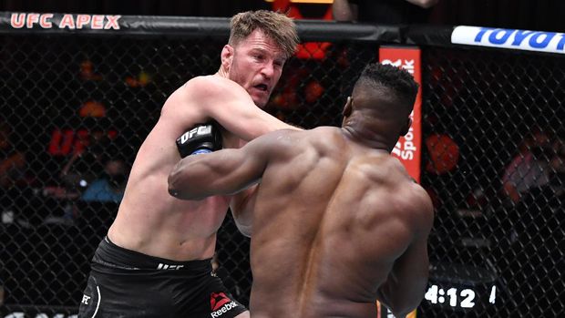 UFC 260 Mar 27, 2021; Las Vegas, NV, USA; Stipe Miocic punches Francis Ngannou of Cameroon in their UFC heavyweight championship fight during the UFC 260 event at UFC APEX on March 27, 2021 in Las Vegas, Nevada. Mandatory Credit: Jeff Bottari/Handout Photo via USA TODAY Sports