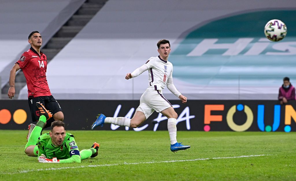 TIRANA, ALBANIA - MARCH 28: Mason Mount of England scores their side's second goal past Etrit Berisha of Albania during the FIFA World Cup 2022 Qatar qualifying match between Albania and England at the Qemal Stafa Stadium on March 28, 2021 in Tirana, Albania. Sporting stadiums around Europe remain under strict restrictions due to the Coronavirus Pandemic as Government social distancing laws prohibit fans inside venues resulting in games being played behind closed doors.  (Photo by Mattia Ozbot/Getty Images)