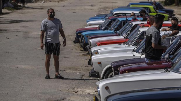 Carlos Rodriguez, president of the Lada Cuba Club, speaks to club members as they meet in Havana, Cuba, Sunday, March 21, 2021. “I’m proud to have him,” Rodriguez said of his white Lada. “I take care of him as if he were my son.