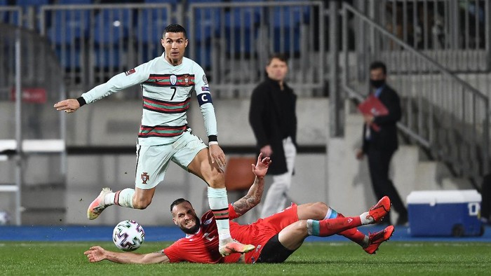 LUXEMBOURG, LUXEMBOURG - MARCH 30: Cristiano Ronaldo of Portugal is challenged by Maxime Chanot of Luxembourg during the FIFA World Cup 2022 Qatar qualifying match between Luxembourg and Portugal on March 30, 2021 in Luxembourg, Luxembourg. Sporting stadiums around Luxembourg remain under strict restrictions due to the Coronavirus Pandemic as Government social distancing laws prohibit fans inside venues resulting in games being played behind closed doors. (Photo by Alexander Scheuber/Getty Images )
