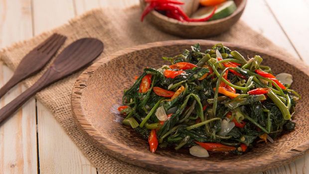 Closeup of cah kangkung, kangkong, or water spinach stirred.