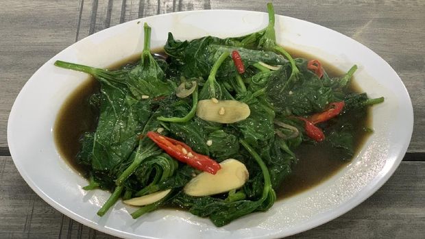 Closeup of cah kangkung, kangkong, or water spinach stirred.