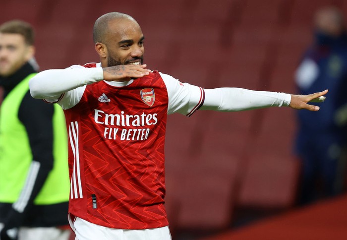 LONDON, ENGLAND - MARCH 14: Alexandre Lacazette of Arsenal celebrates after scoring their side's second goal from the penalty spot during the Premier League match between Arsenal and Tottenham Hotspur at Emirates Stadium on March 14, 2021 in London, England. Sporting stadiums around the UK remain under strict restrictions due to the Coronavirus Pandemic as Government social distancing laws prohibit fans inside venues resulting in games being played behind closed doors. (Photo by Julian Finney/Getty Images)