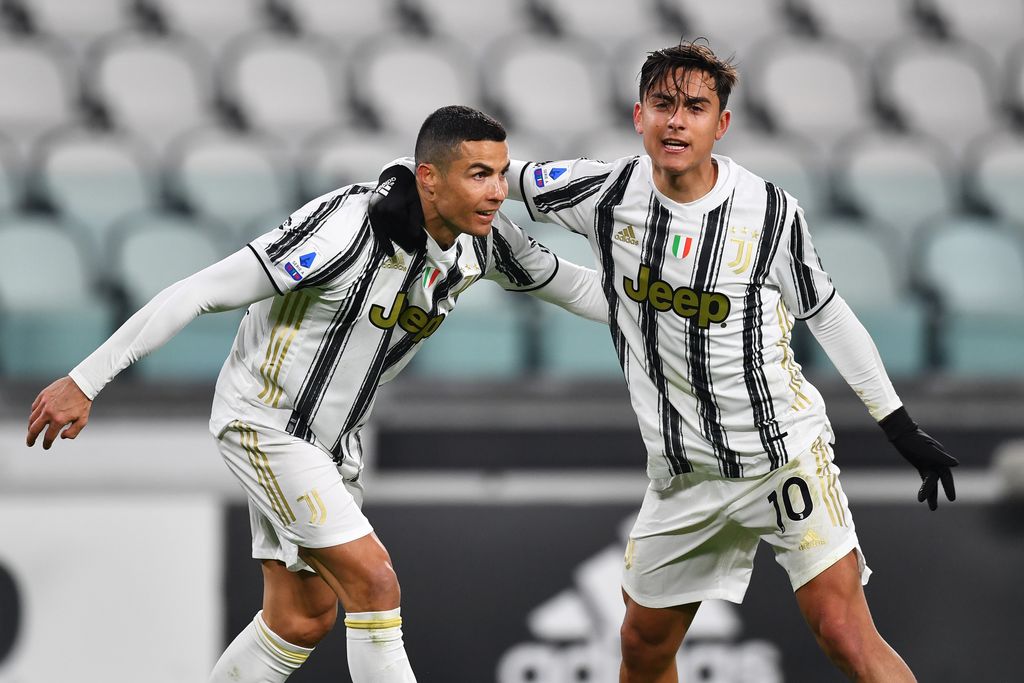 TURIN, ITALY - JANUARY 03: Cristiano Ronaldo of Juventus F.C.  celebrates with teammate Paulo Dybala after scoring their team's first goal during the Serie A match between Juventus and Udinese Calcio at Allianz Stadium on January 03, 2021 in Turin, Italy. Sporting stadiums around Italy remain under strict restrictions due to the Coronavirus Pandemic as Government social distancing laws prohibit fans inside venues resulting in games being played behind closed doors. (Photo by Valerio Pennicino/Getty Images)