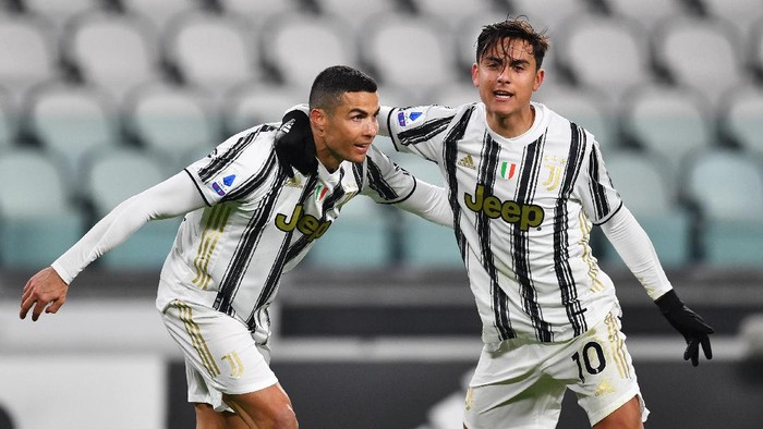 TURIN, ITALY - JANUARY 03: Cristiano Ronaldo of Juventus F.C.  celebrates with teammate Paulo Dybala after scoring their teams first goal during the Serie A match between Juventus and Udinese Calcio at Allianz Stadium on January 03, 2021 in Turin, Italy. Sporting stadiums around Italy remain under strict restrictions due to the Coronavirus Pandemic as Government social distancing laws prohibit fans inside venues resulting in games being played behind closed doors. (Photo by Valerio Pennicino/Getty Images)