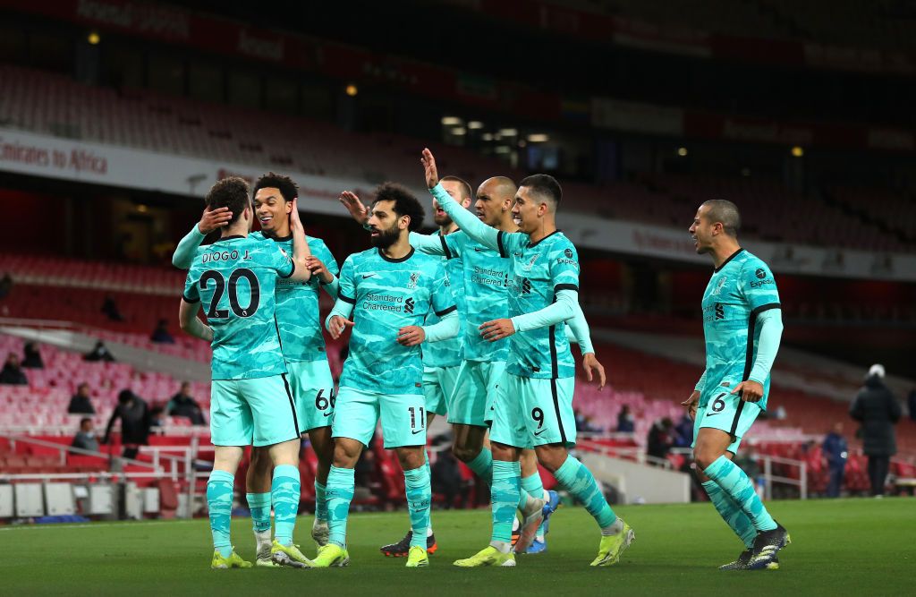 LONDON, ENGLAND - APRIL 03: Diogo Jota of Liverpool celebrates with Trent Alexander-Arnold, Mohamed Salah and teammates after scoring his team's first goal during the Premier League match between Arsenal and Liverpool at the Emirates Stadium on April 3, 2021 in London, England.  Sports stadiums across the UK remain under strict restrictions due to the coronavirus pandemic, as government social distancing laws prohibit fans within venues, causing games to be played behind closed doors.  (Photo by Catherine Ivill / Getty Images)