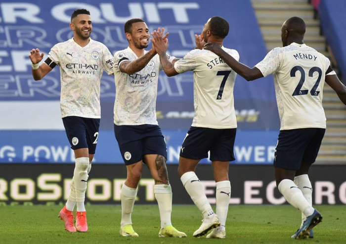 LEICESTER, ENGLAND - APRIL 03: Gabriel Jesus of Manchester City celebrates with teammates Riyad Mahrez, Raheem Sterling and Benjamin Mendy after scoring their teams second goal during the Premier League match between Leicester City and Manchester City at The King Power Stadium on April 03, 2021 in Leicester, England. Sporting stadiums around the UK remain under strict restrictions due to the Coronavirus Pandemic as Government social distancing laws prohibit fans inside venues resulting in games being played behind closed doors. (Photo by Rui Vieira - Pool/Getty Images)