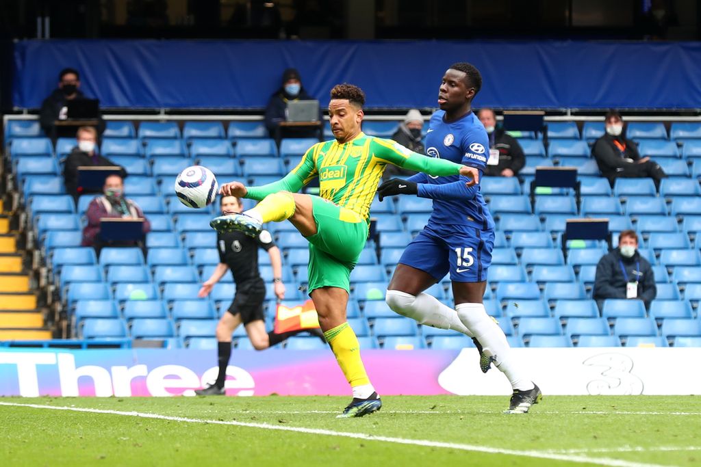 LONDON, ENGLAND - APRIL 03: Matheus Pereira of West Bromwich Albion scores their team's first goal under pressure from Kurt Zouma of Chelsea during the Premier League match between Chelsea and West Bromwich Albion at Stamford Bridge on April 03, 2021 in London, England. Sporting stadiums around the UK remain under strict restrictions due to the Coronavirus Pandemic as Government social distancing laws prohibit fans inside venues resulting in games being played behind closed doors. (Photo by Clive Rose/Getty Images)