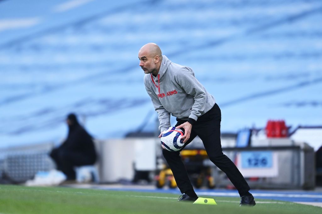 MANCHESTER, ENGLAND - MARCH 07: Pep Guardiola, Manager of Manchester City collects the ball during the Premier League match between Manchester City and Manchester United at Etihad Stadium on March 07, 2021 in Manchester, England. Sporting stadiums around the UK remain under strict restrictions due to the Coronavirus Pandemic as Government social distancing laws prohibit fans inside venues resulting in games being played behind closed doors. (Photo by Laurence Griffiths/Getty Images)