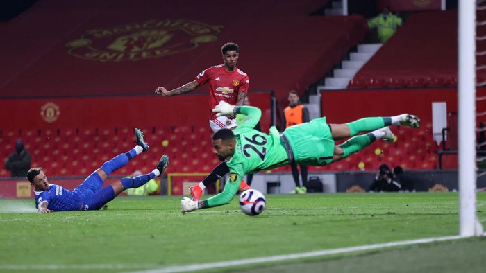 MANCHESTER, ENGLAND - APRIL 04: Marcus Rashford of Manchester United scores their teams first goal past Robert Sanchez of Brighton & Hove Albion during the Premier League match between Manchester United and Brighton & Hove Albion at Old Trafford on April 04, 2021 in Manchester, England. Sporting stadiums around the UK remain under strict restrictions due to the Coronavirus Pandemic as Government social distancing laws prohibit fans inside venues resulting in games being played behind closed doors. (Photo by Clive Brunskill/Getty Images)