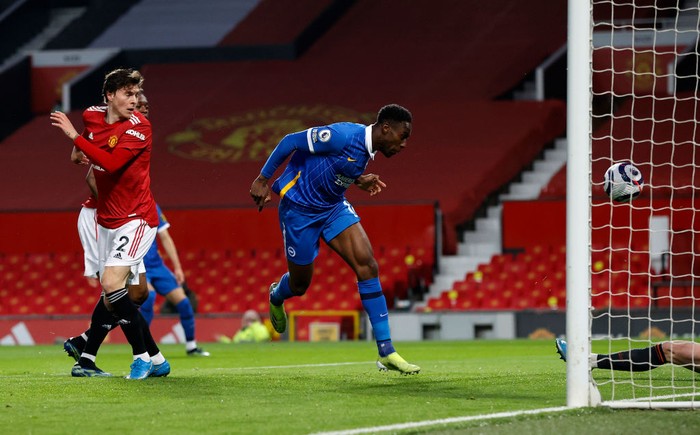 MANCHESTER, ENGLAND - APRIL 04: Danny Welbeck of Brighton & Hove Albion scores their teams first goal during the Premier League match between Manchester United and Brighton & Hove Albion at Old Trafford on April 04, 2021 in Manchester, England. Sporting stadiums around the UK remain under strict restrictions due to the Coronavirus Pandemic as Government social distancing laws prohibit fans inside venues resulting in games being played behind closed doors. (Photo by Phil Noble - Pool/Getty Images)