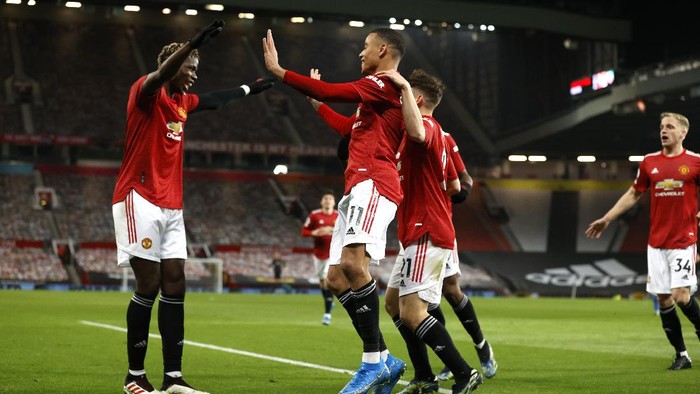 Manchester Uniteds Mason Greenwood, centre, celebrates after scoring his sides second goal during the English Premier League soccer match between Manchester United and Brighton and Hove Albion at Old Trafford, Manchester, England, Sunday, Apr. 4, 2021. (Phil Noble/Pool via AP)