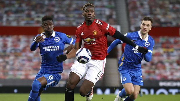 Soccer Football - Premier League - Manchester United v Brighton & Hove Albion - Old Trafford, Manchester, Britain - April 4, 2021 Brighton & Hove Albion's Joel Veltman and Yves Bissouma in action with Manchester United's Paul Pogba Pool via REUTERS/Phil Noble EDITORIAL USE ONLY. No use with unauthorized audio, video, data, fixture lists, club/league logos or 'live' services. Online in-match use limited to 75 images, no video emulation. No use in betting, games or single club /league/player publications.  Please contact your account representative for further details.