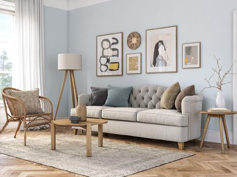 Bohemian living room interior 3d render with  beige colored furniture and wooden elements and light blue colored wall