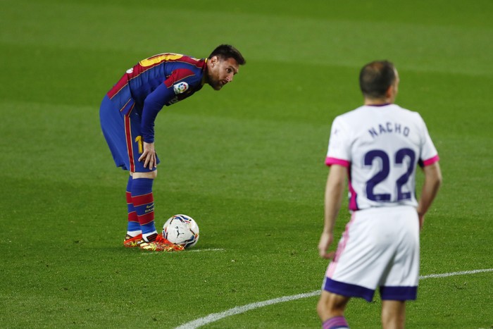 Barcelonas Lionel Messi prepares to takes a free kick during the Spanish La Liga soccer match between FC Barcelona and Valladolid CF at the Camp Nou stadium in Barcelona, Spain, Monday, April 5, 2021. (AP Photo/Joan Monfort)