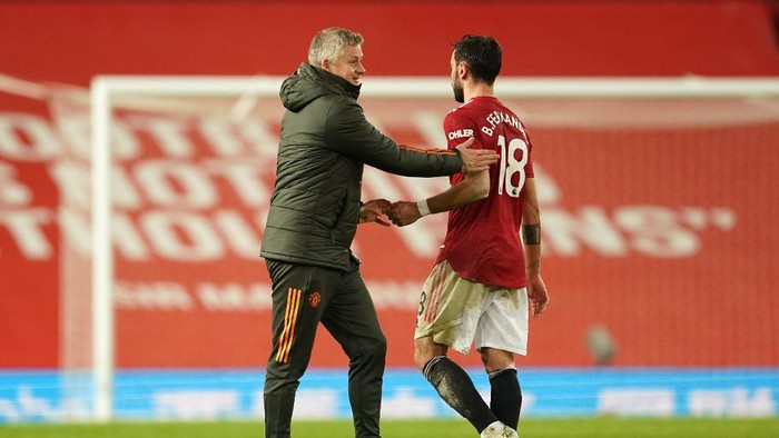MANCHESTER, ENGLAND - MARCH 14: Ole Gunnar Solskjaer, Manager of Manchester United interacts with Bruno Fernandes of Manchester United following the Premier League match between Manchester United and West Ham United at Old Trafford on March 14, 2021 in Manchester, England. Sporting stadiums around the UK remain under strict restrictions due to the Coronavirus Pandemic as Government social distancing laws prohibit fans inside venues resulting in games being played behind closed doors. (Photo by Dave Thompson - Pool/Getty Images)