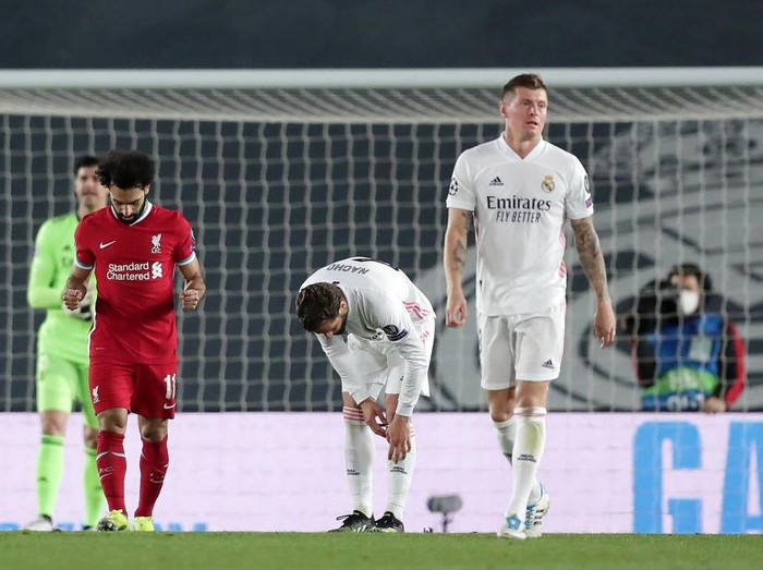 MADRID, SPAIN - APRIL 06: Mohamed Salah of Liverpool (L) celebrates after scoring his teams first goal as Toni Kroos of Real Madrid (R) look dejected during the UEFA Champions League Quarter Final match between Real Madrid and Liverpool FC at Estadio Alfredo Di Stefano on April 06, 2021 in Madrid, Spain. Sporting stadiums around Spain remain under strict restrictions due to the Coronavirus Pandemic as Government social distancing laws prohibit fans inside venues resulting in games being played behind closed doors. (Photo by Gonzalo Arroyo Moreno/Getty Images)