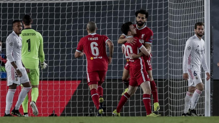 Liverpool players celebrate after scoring their team first goal during the Champions League quarterfinal first leg, soccer match between Real Madrid and Liverpool at the Alfredo di Stefano stadium in Madrid, Spain, Tuesday, April 6, 2021. (AP Photo/Manu Fernandez)