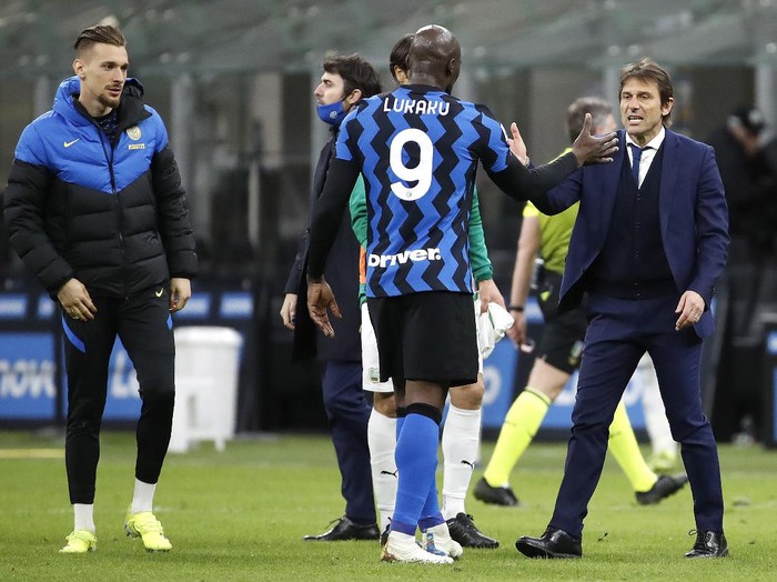 Inter Milan's head coach Antonio Conte with his player Romelu Lukaku, center, after the end of the Serie A soccer match between Inter Milan and Sassuolo at the San Siro Stadium in Milan, Italy, Wednesday, April 7, 2021. Inter Milan win the game 2-1. (AP Photo/Antonio Calanni)