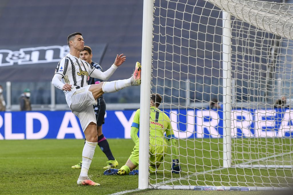 Juventus' Cristiano Ronaldo heads the ball during the Italian Serie A soccer match between Juventus and Napoli at the Allianz Stadium in Turin, Italy, Wednesday, April 7, 2021. (Fabio Ferrari/LaPresse via AP)