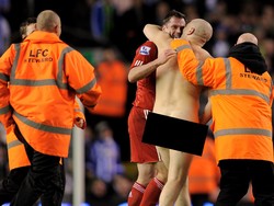 Jamie Carragher, semasa main di Liverpool, membantu steward mengawal fans yang menyusup untuk angkat kaki dari lapangan di laga Piala FA lawan Brighton pada 19 Februari 2012. Foto: Michael Regan/Getty Images/Edit