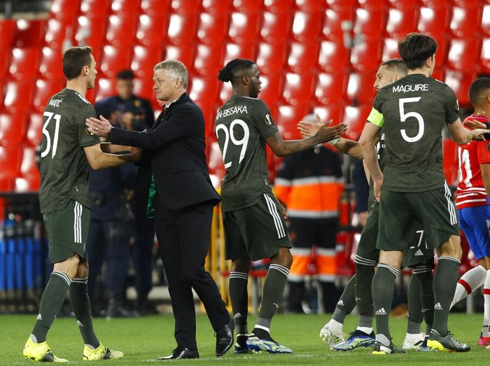 Manchester United's manager Ole Gunnar Solskjaer greets his players after the Europa League, quarterfinal, first leg soccer match between Granada and Manchester United at the Los Carmenes stadium in Granada, Spain, Thursday, April 8, 2021. (AP Photo/Fermin Rodriguez)