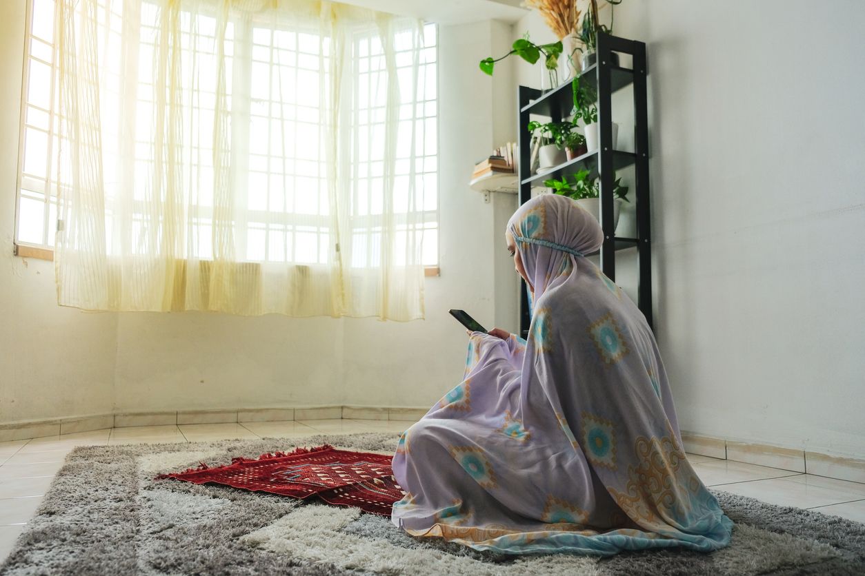 Muslim family using mobile at home during ramadhan