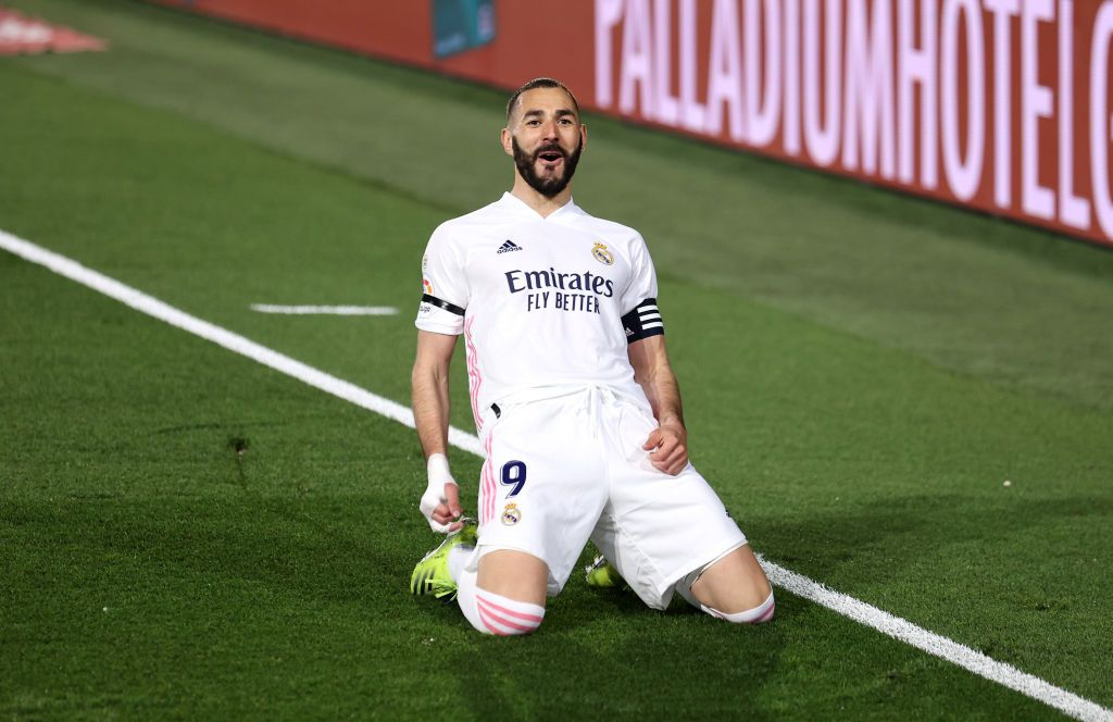 MADRID, SPAIN - APRIL 10: Karim Benzema of Real Madrid celebrates after scoring their side's first goal during the La Liga Santander match between Real Madrid and FC Barcelona at Estadio Alfredo Di Stefano on April 10, 2021 in Madrid, Spain. Sporting stadiums around Spain remain under strict restrictions due to the Coronavirus Pandemic as Government social distancing laws prohibit fans inside venues resulting in games being played behind closed doors.  (Photo by Angel Martinez/Getty Images)