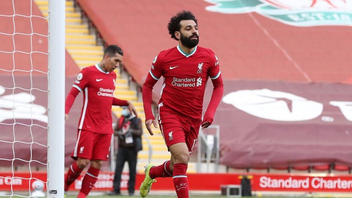 LIVERPOOL, ENGLAND - APRIL 10: Mohamed Salah of Liverpool celebrates after scoring their teams first goal during the Premier League match between Liverpool and Aston Villa at Anfield on April 10, 2021 in Liverpool, England. Sporting stadiums around the UK remain under strict restrictions due to the Coronavirus Pandemic as Government social distancing laws prohibit fans inside venues resulting in games being played behind closed doors.  (Photo by Martin Rickett - Pool/Getty Images)