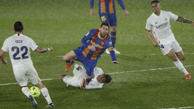 Barcelona's Lionel Messi, center top, is tackled by Real Madrid's Casemiro during the Spanish La Liga soccer match between Real Madrid and FC Barcelona at the Alfredo di Stefano stadium in Madrid, Spain, Saturday, April 10, 2021. Real Madrid won 2-1. (AP Photo/Manu Fernandez)