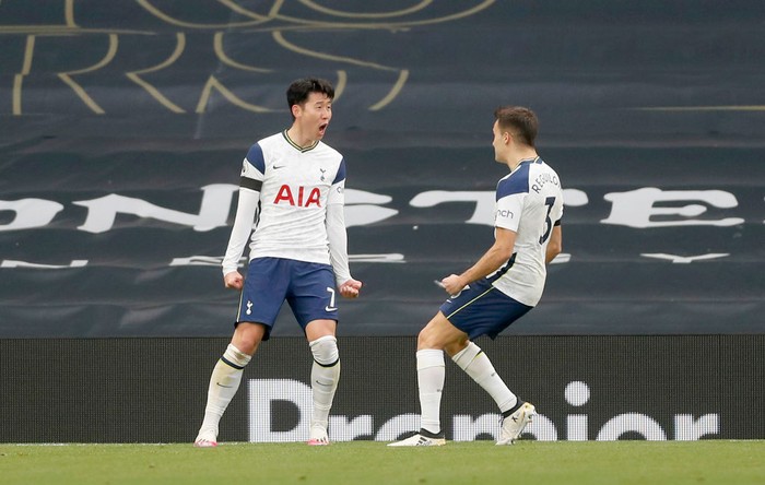 LONDON, ENGLAND - APRIL 11: Son Heung-Min of Tottenham Hotspur celebrates with Sergio Reguilon after scoring their teams first goal during the Premier League match between Tottenham Hotspur and Manchester United at Tottenham Hotspur Stadium on April 11, 2021 in London, England. Sporting stadiums around the UK remain under strict restrictions due to the Coronavirus Pandemic as Government social distancing laws prohibit fans inside venues resulting in games being played behind closed doors. (Photo by Matthew Childs - Pool/Getty Images)