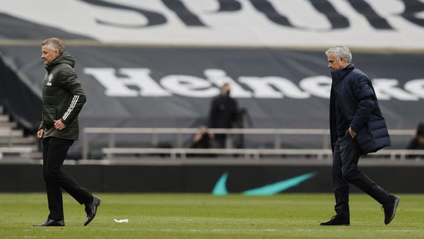 Tottenham's manager Jose Mourinho, right and Manchester United's manager Ole Gunnar Solskjaer leave the field at the and of the English Premier League soccer match between Tottenham Hotspur and Manchester United at the Tottenham Hotspur Stadium in London, Sunday, April 11, 2021. (Adrian Dennis/Pool via AP)