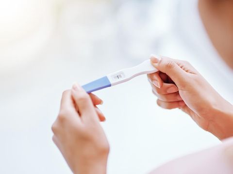 Cropped shot of a young woman taking a pregnancy test