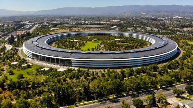 Sunnyvale, California, USA - July 30, 2019: Cars driving past Apple Park, an iconic building located in Sunnyvale California. This image was taken on the morning of July 30, 2019. Apple Park serves as the international headquarters of Apple, Inc. The roof contains solar arrays that power the building.