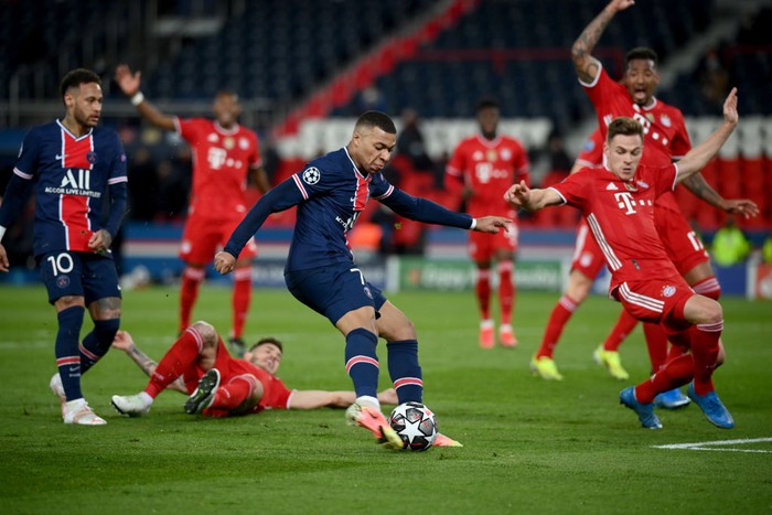 PARIS, FRANCE - APRIL 13: Kylian Mbappe of Paris Saint-Germain breaks away to shpoo during the UEFA Champions League Quarter Final Second Leg match between Paris Saint-Germain and FC Bayern Munich at Parc des Princes on April 13, 2021 in Paris, France. Sporting stadiums around France remain under strict restrictions due to the Coronavirus Pandemic as Government social distancing laws prohibit fans inside venues resulting in games being played behind closed doors. (Photo by Matthias Hangst/Getty Images)
