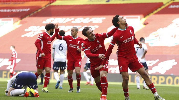Liverpools Trent Alexander-Arnold, right, celebrates after scoring his sides second goal during the English Premier League soccer match between Liverpool and Aston Villa at Anfield stadium in Liverpool, England, Saturday, April 10, 2021. (Clive Brunskill/Pool via AP)
